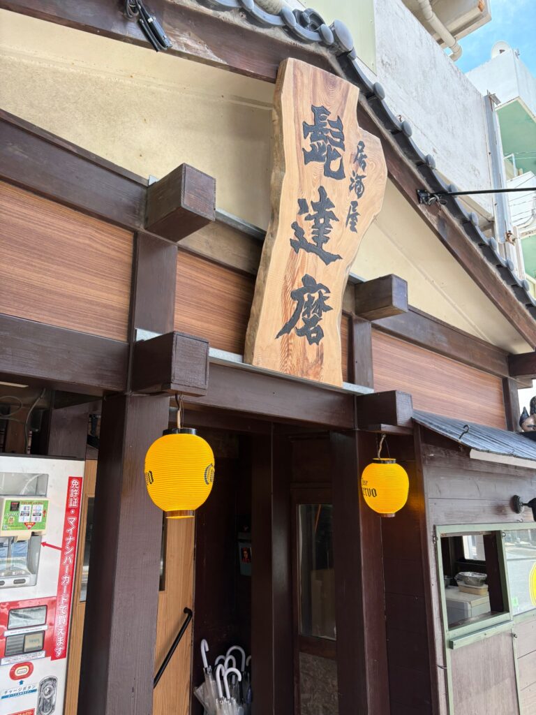 居酒屋 髭達磨 小禄店の木製看板と黄色い提灯